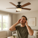 Ceiling fan spinning above living room, person looking up concerned